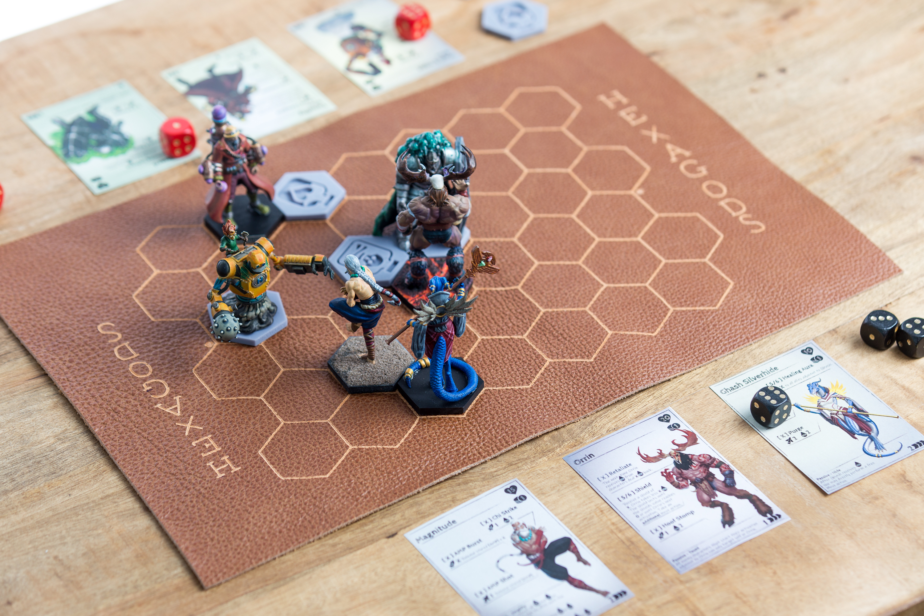 Two players mid-match across the Hexagods battle mat